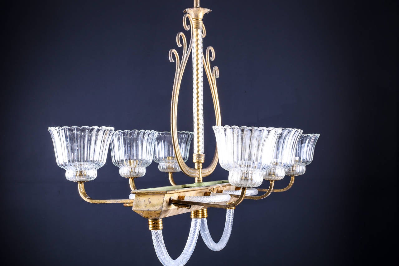 1930′s Venetian Brass & Clear Murano Glass Chandelier in the style of Barovier & Toso

Option: Height can be shortened if necessary.
Total Depth: 23