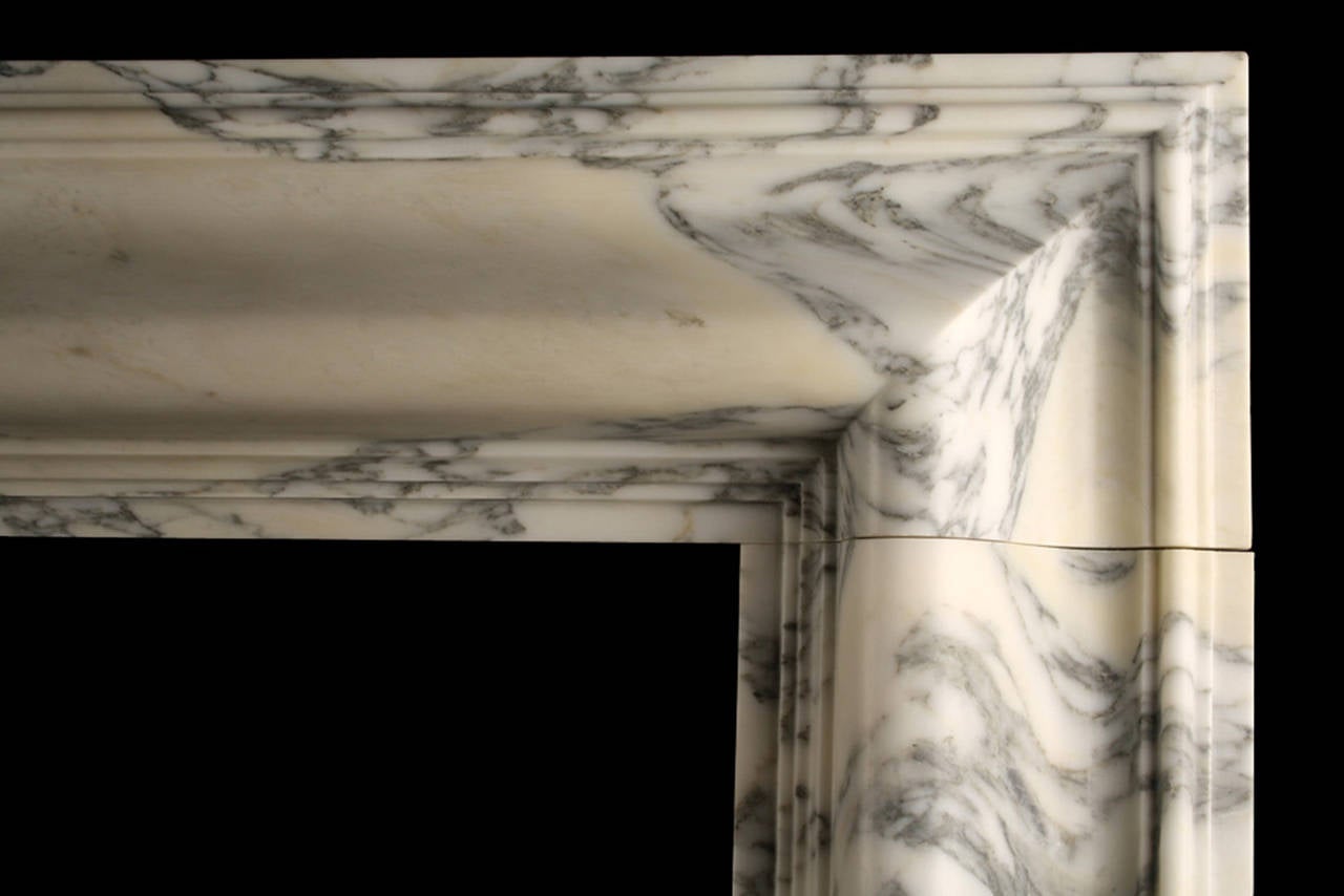 A Baroque Bolection Fireplace in Italian Arabescato Marble

A Baroque style Bolection Fireplace surround of bold proportions with very finely carved columns with a rising ogee edging, which are supported on substantial footblocks, in High Quality