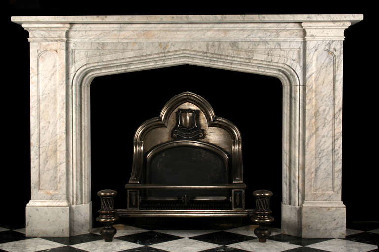 A large Antique early Victorian Fireplace surround in the Gothic revival manner, very finely carved in high quality blue veined Pencil white Carrara marble. With inset panelled jambs with tracery carved detail and similarly carved frieze. Pictured