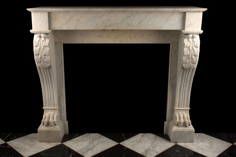 An Antique Louis XVI Fireplace Surround finely carved in lightly veined White Carrara marble, with acanthus leaf carved scrolled tops and richly carved Lion Paw feet, French Circa 1850.

Depth: 16