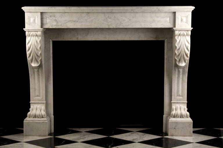 An Original Louis XVI Chimneypiece finely carved in lightly veined White Carrara marble, with acanthus leaf carved scrolled tops and richly carved Lion Paw feet, French mid-19th Century.

Depth: 16