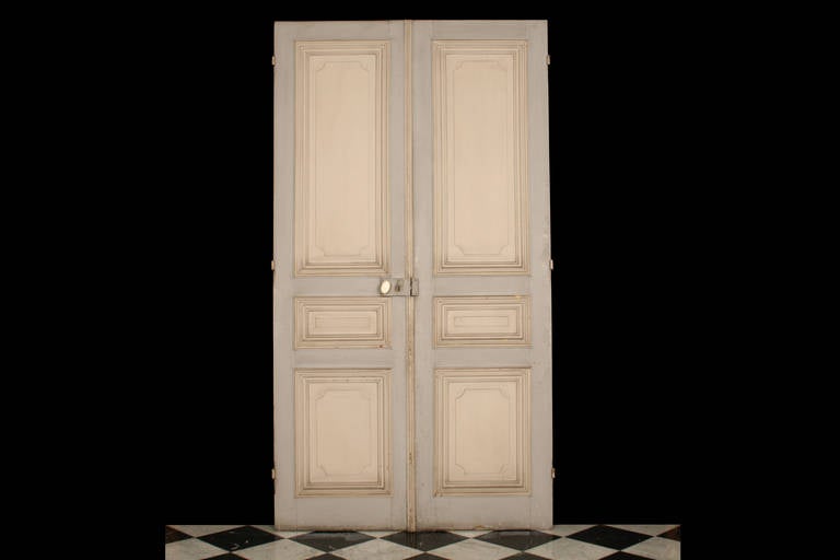 An Antique pair of Large Oak Doors with Pine Mouldings and panelled decoration in the Louis XVI manner, French 19th century.

Total Depth: 3 1/4