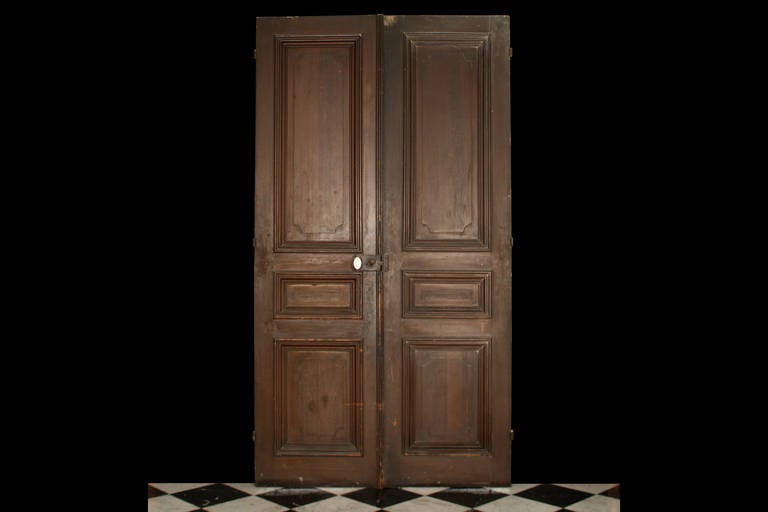 An Antique pair of Large Oak Doors with Pine Mouldings and panelled decoration in the Louis XVI manner, French 19th century.

Total Depth: 3 1/4