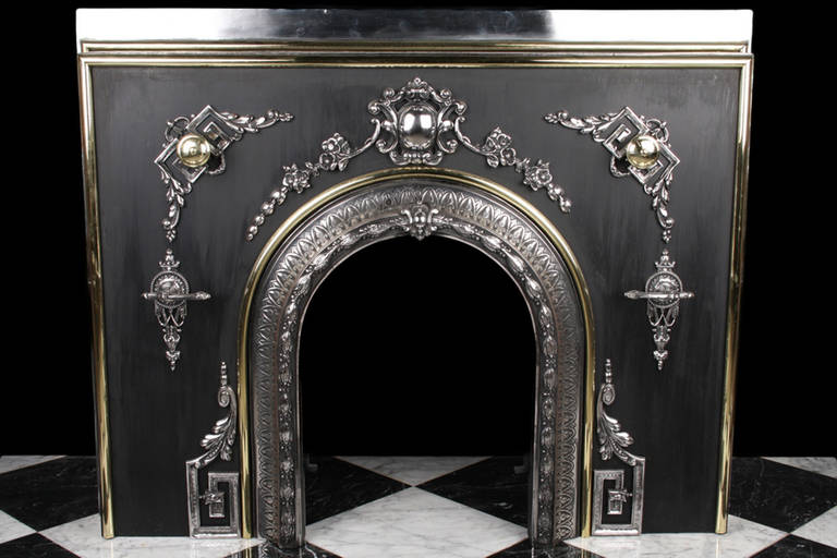 A large antique arched register fire grate, highly polished, highly decorative, made in rare Paktong or Tutenag also known as 