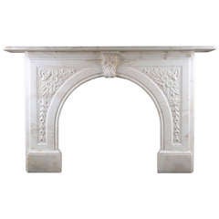An Antique Victorian Arched Fireplace Surround In White Statuary Marble