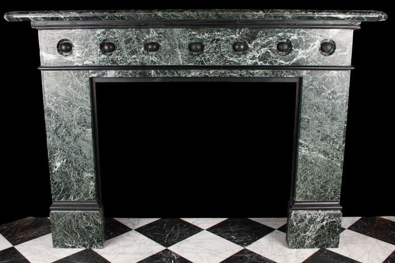 Large Victorian in Verde Antico and Belgium Black marble fire surround. The frieze is decorated with black marble bosses. English mid 19th Century.

Depth: 11 1/2