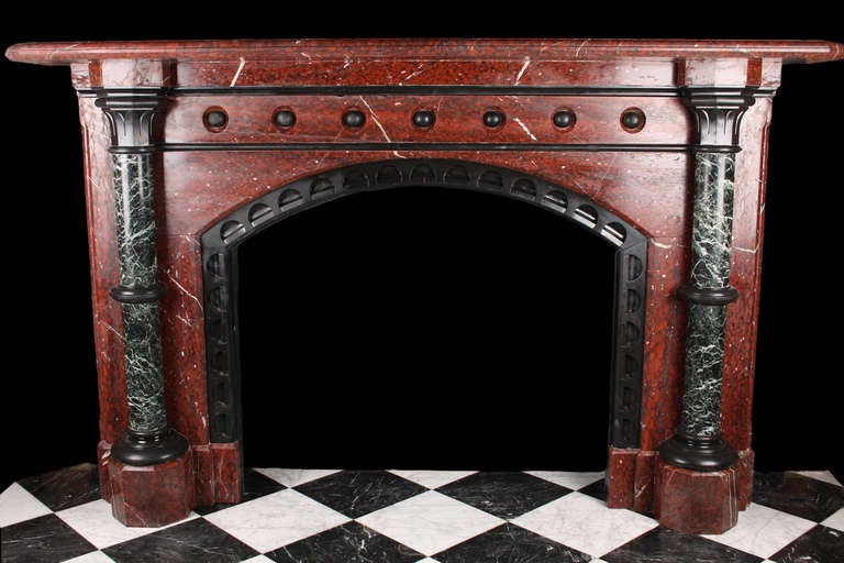 A substantial antique Regency fireplace in solid Rouge Griotte, Belgium Black and Verde Antico marble, with a segmental arched opening, the jambs with Verde Antico columns, English , circa 1820.

Depth: 15