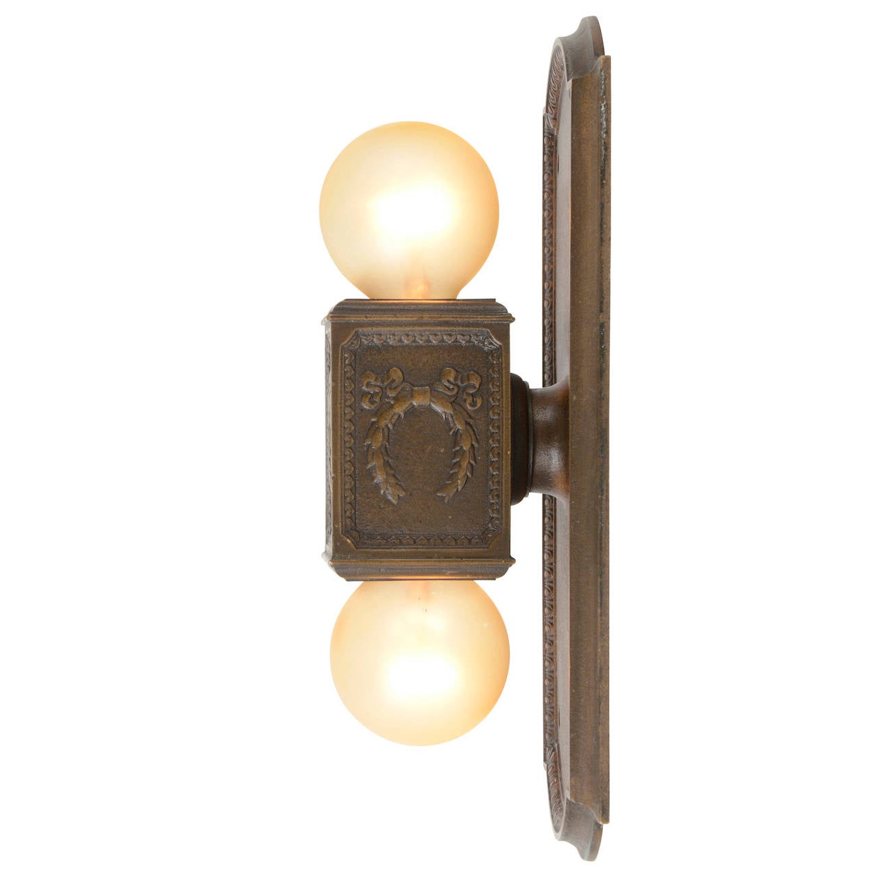 This impressive cast bronze sconce has a foot firmly planted in two different camps. One belongs in the world of Classical design, as egg and dart trim, bay leaf patterning and festoons adorn the fixture. The other foot stands proudly in the realm