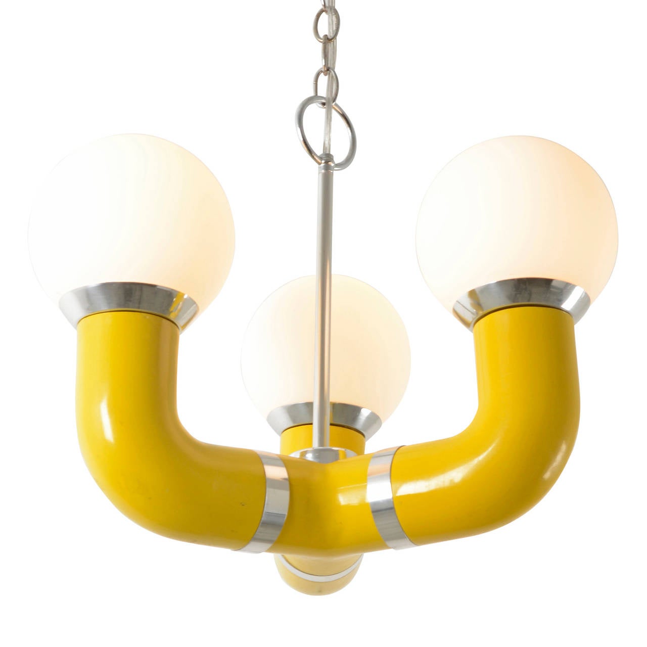 With all of the trappings of the late Mid-Century Mod revolution, this yellow and chrome three-arm chandelier brings unexpected shapes and finishes together to form the kind of light that could belong on Stanley Kubrick's Discovery One space Craft.