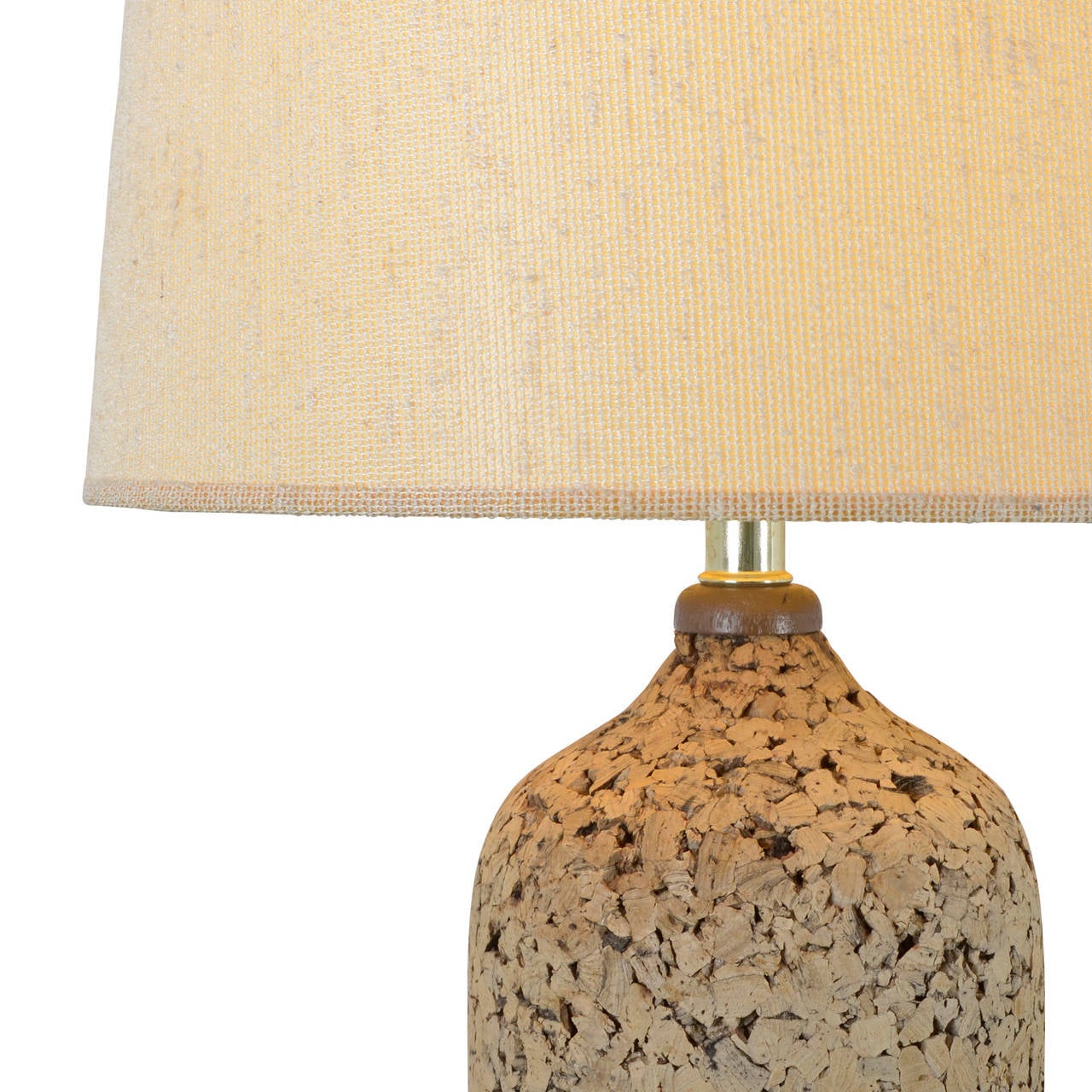 This table lamp hails from the mid-1960s, a time when the Mid-Century Modern minimalism was, like the country, loosening up and embracing its wild side. This groovy table lamp features a cork-coated body, set on a wooden base and capped with a large
