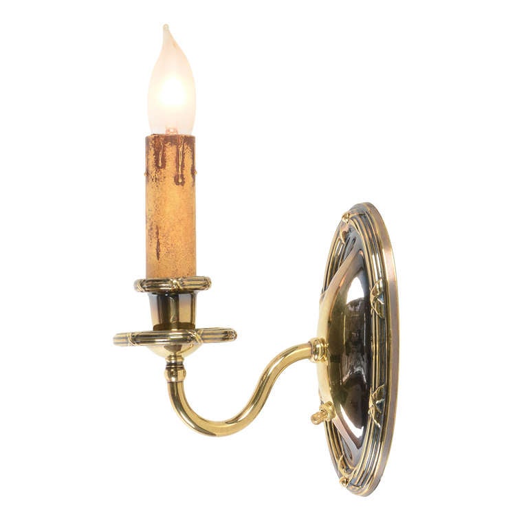 Typical of the stamped brass Classical or Colonial Revival fixtures of the late 1910s and early 1920s, this classic pair of sconces might have been in a house of just about any style - folks were just as eclectic back then as today, and this style