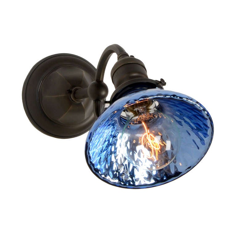 This Simple pair of sconces with Hexagonal Canopy was common in the earlier part of the 1900's.  The cool factor comes in with the shiny blue silvered or 