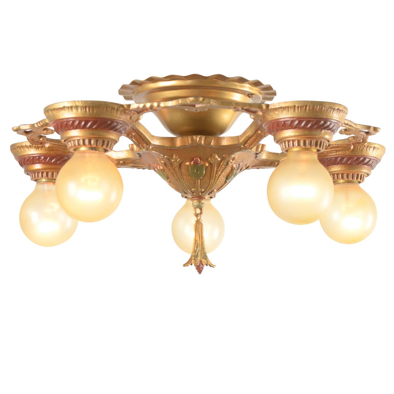 The late 1920s saw an explosion in the popularity of decorative cast white-metal fixtures with exposed globe bulbs and rich polychrome finishes like this example. Romantically decorative, this fixture has the added advantage of being a semi-flush