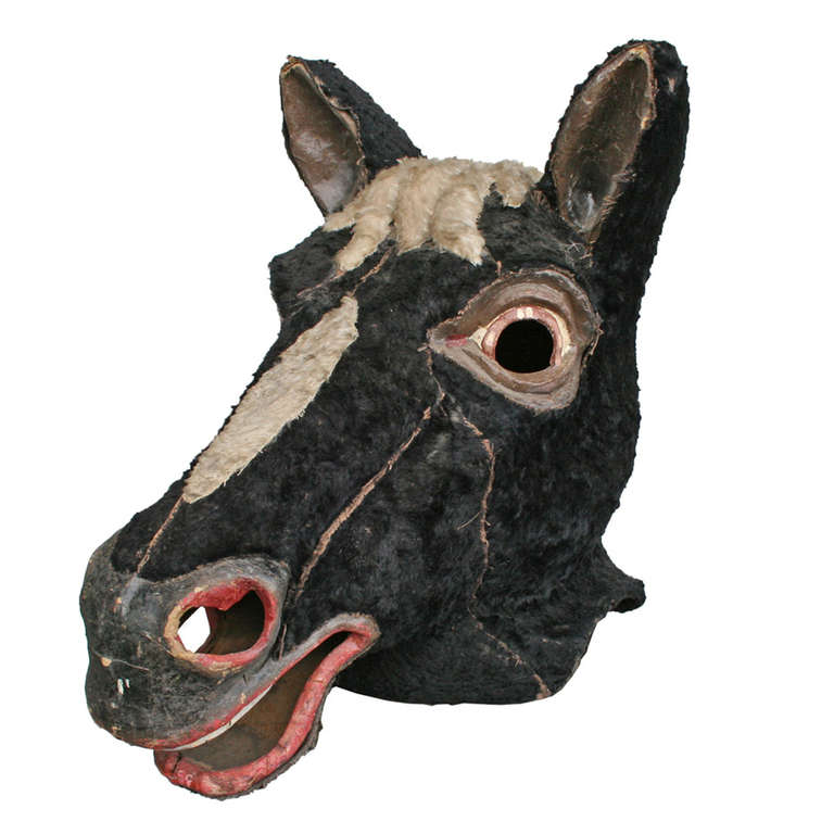 Lions and tigers and bears, oh my! This piece of playful history comes to us as part of a collection of 20 carnival mascot heads. Hand crafted from paper mache, real horse hyde and imagination, this dashing stead is also comprised of nearly a