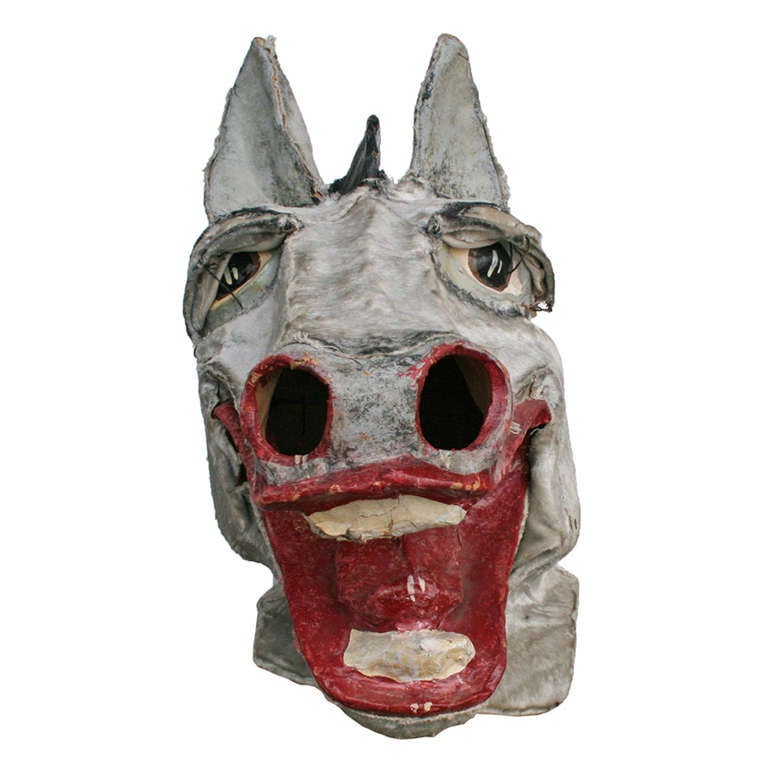 Lions and tigers and bears, oh my! This piece of playful history comes to us as part of a collection of 20 masks from an historic family costume shop. Hand made from papier mâché, velvet and imagination, this jolly mare is also comprised of nearly a
