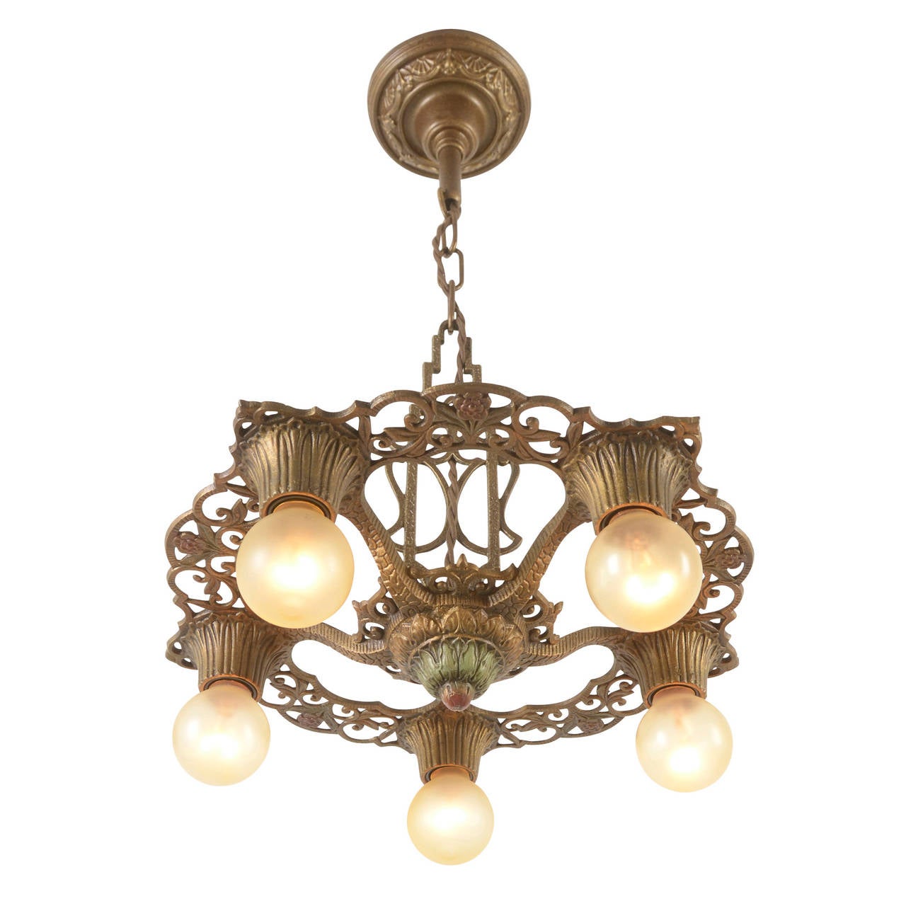 The late-1920s saw an explosion in the popularity of decorative cast white-metal fixtures with exposed globe bulbs and rich polychrome finishes like this example. Undeniably and unabashedly decorative, this fixture enhances its finely cast details