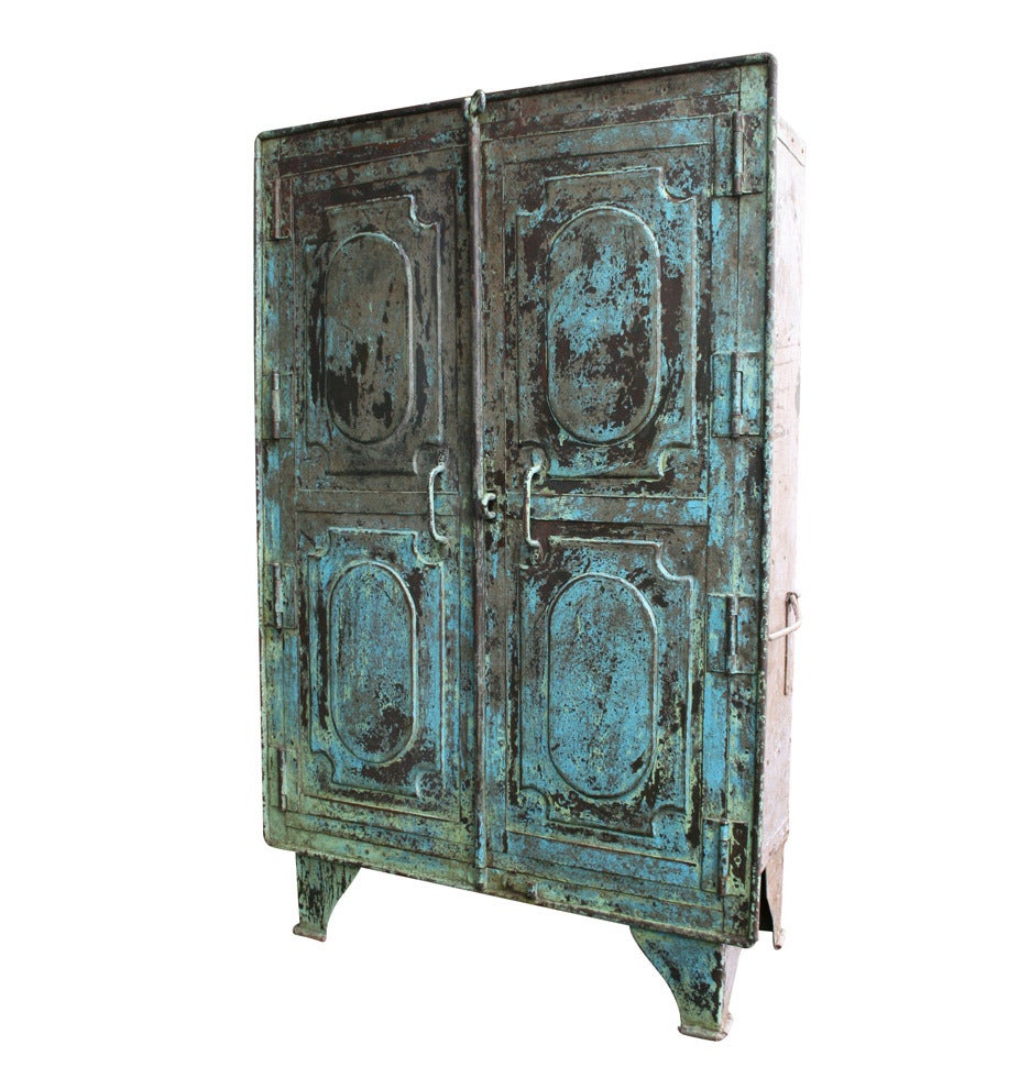 We are in love. This stunning steel armoire brings absolutely everything to the table: chased and stamped steel, ample storage for extra functionality, and an elegantly refined composition, which is off-set by the rustic blue and green finish,