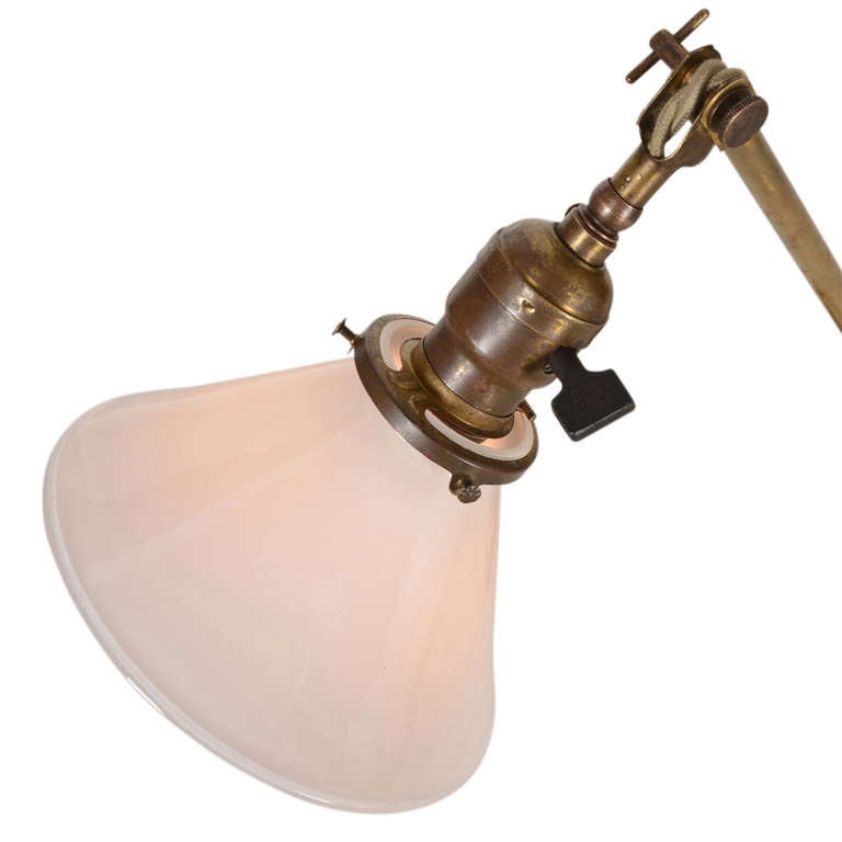 A classic example of the two-knuckle adjustable desk lamp popularized by Faries, and imitated by Dale and others, this one features restored brown twisted cord, pairs of wing nuts for the adjustable joints, an original turnkey socket with clamp-on