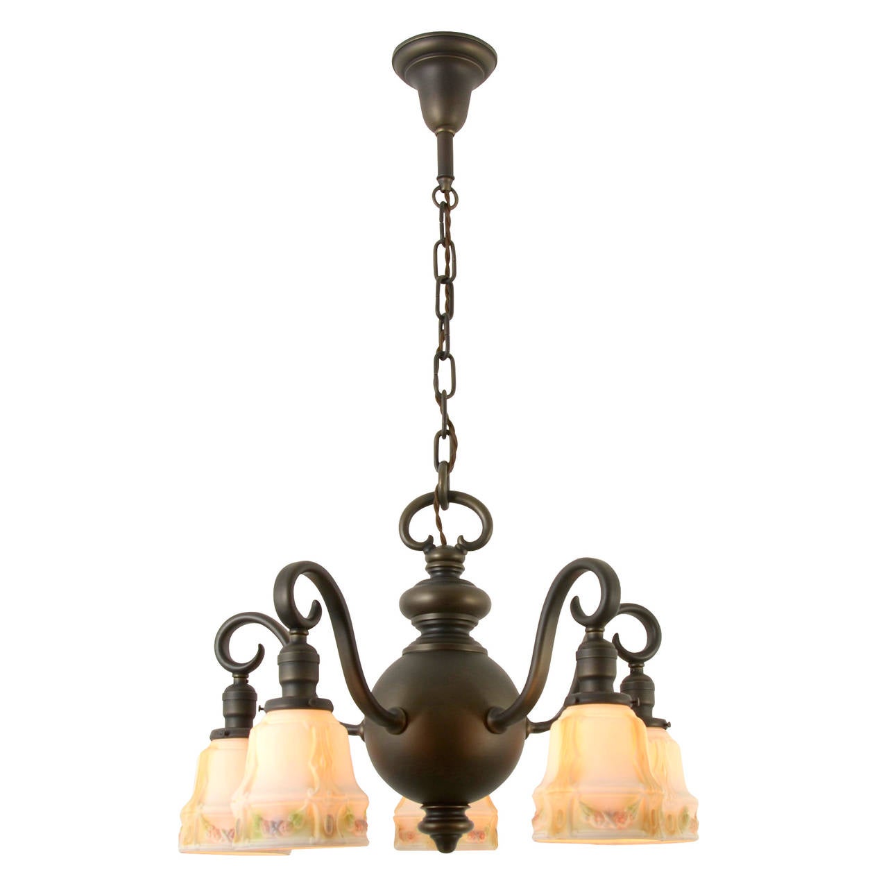 A little goes a long way with this remarkable Colonial Revival chandelier. Ornate without being ostentatious, design elements include a turned spherical body that terminates in a traditional finial and impressive swooping armbacks. The delicately