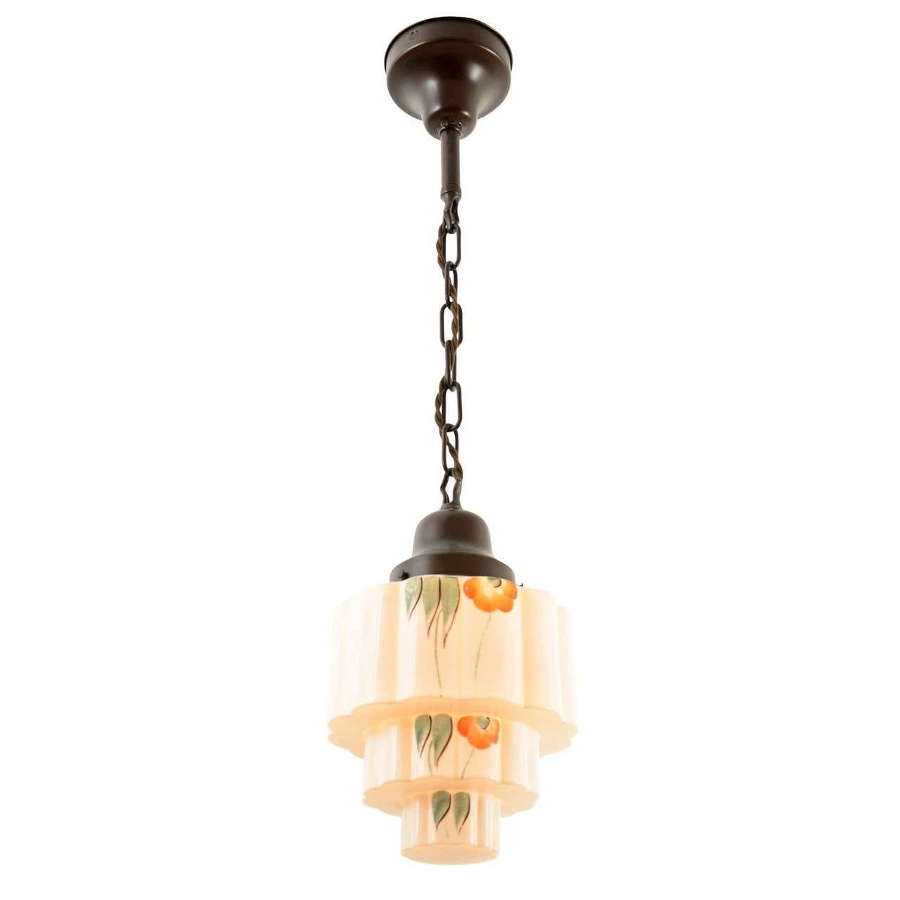 A classic flush pendant is simply the quiet vehicle for a gorgeous hand-painted shade. Mixing a colorful stylized floral motif with orange, yellow and green on a dramatic stepped glass shape, this shade displays Art Deco influences in their more