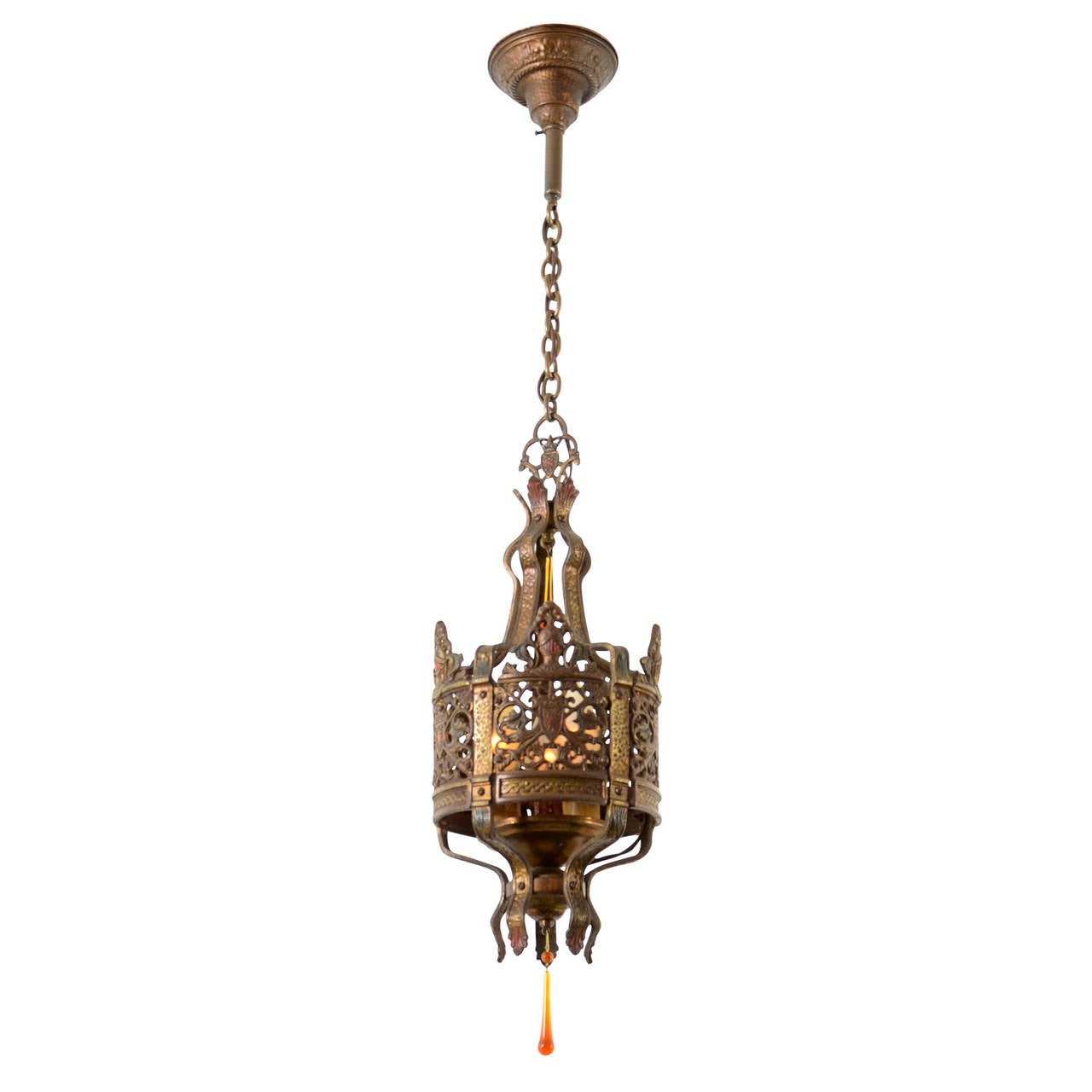 Wrought-iron inspired fixtures like this one were popular in the second half of the 1920s, where they romantically lit countless Tudor, English, and Mediterranean cottages. This example features cameo-style knights' helmets emblazoned upon heraldic
