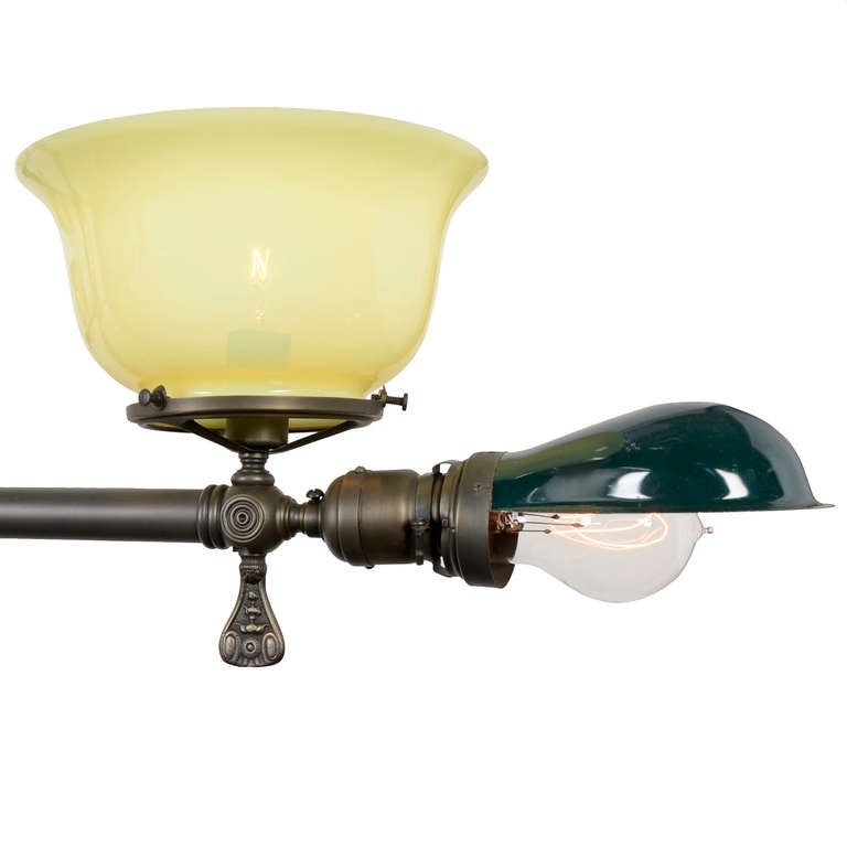 This stunning four arm billiard chandelier dates to the early 1900s, a time when the game of billiards was gaining popularity and Victorian ornate design was giving way to the less decorative styles of the early 20th century. Handcrafted with long