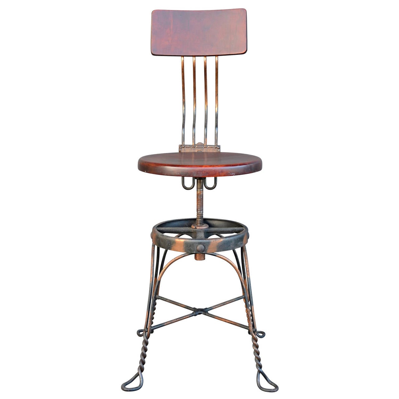 This Victorian-era desk chair comes with a twist (pun intended). The wrought iron base features some of the most wonderful japanned copper finish we've ever seen, which only serves to highlight the ornate casting and wire-work . We also love the
