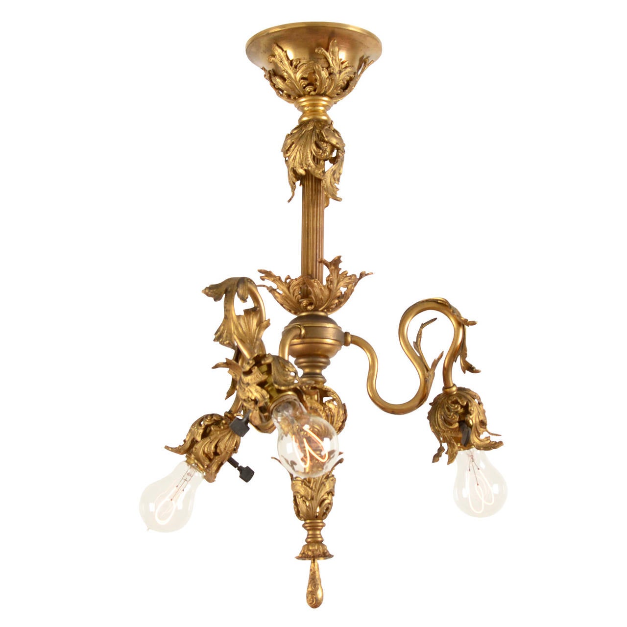 It was love at first sight when we laid eyes on this stunning gilt Rococo fin de siècle chandelier. Complete with original 'round sausage key' GE light sockets, this incredible piece features its original fire gilt finish, which carries the kind of