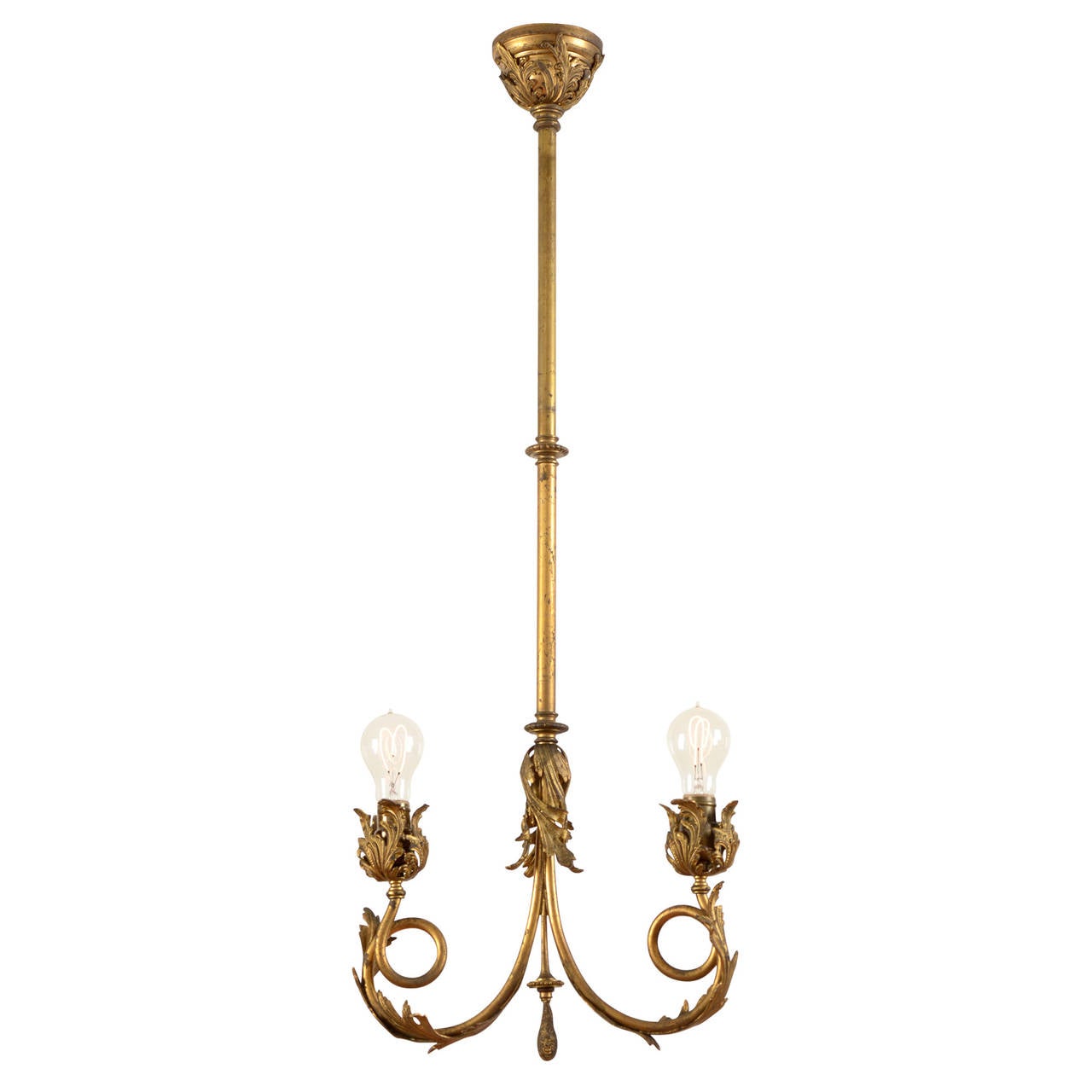 It was love at first sight when we laid eyes on this stunning gilt Rococo fin de siècle chandelier. Complete with original 'round sausage key' GE light sockets, this incredible piece features its original fire gilt finish, which carries the kind of