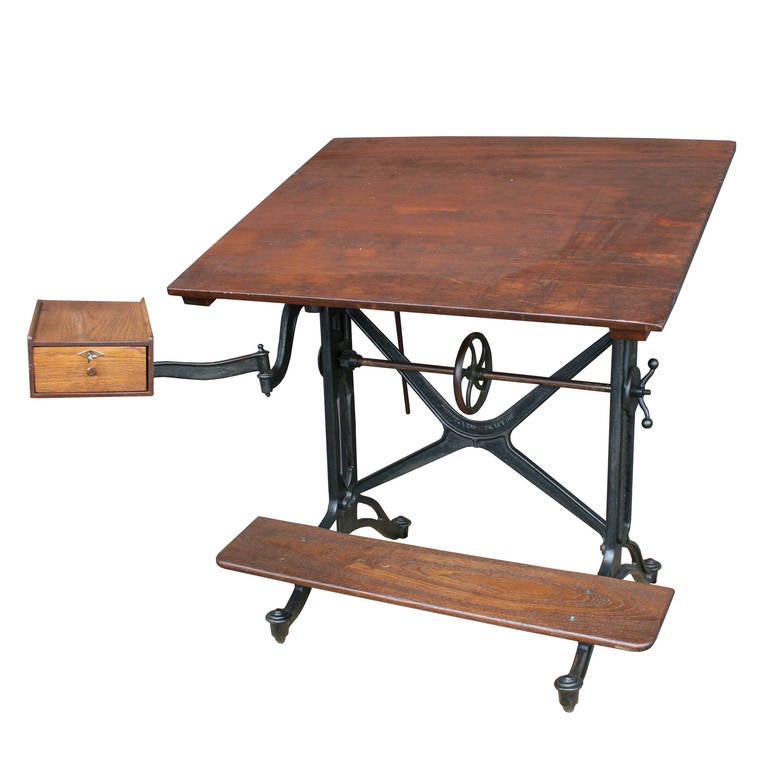 Comprised of cast iron and solid oak, this iconic Keuffel & Esser drafting table is exemplary of the high-end drafting and surveying products made by the New York based company at the turn of the century. This edition offers a complete range of