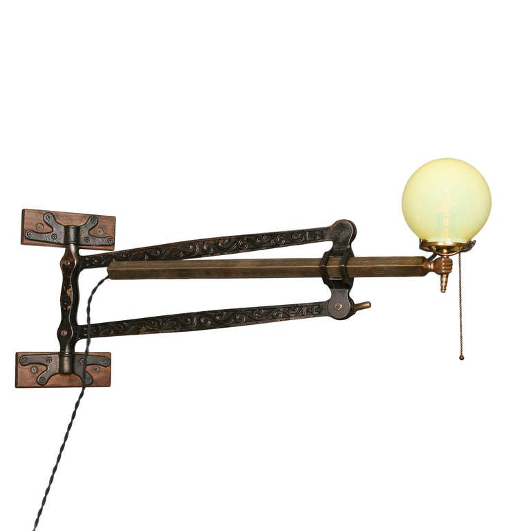 We're not sure about the origins or overall integrity of this fixture, but with something this unique, who cares? (We think it could originally have been a dentist's instrument tray holder.) A mix of decorative cast iron and brass, this light