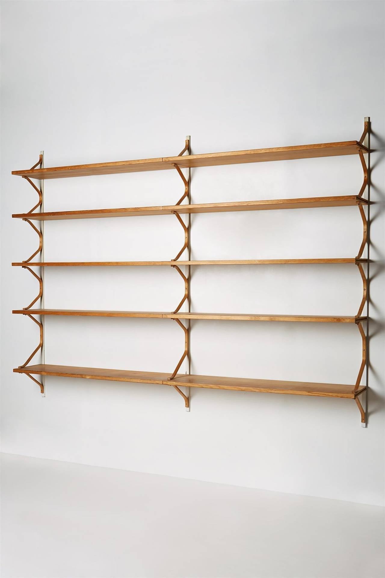 Wall hung bookshelves designed by Bruno Mathsson for Karl Mathsson, Sweden. 1940s.

Lacquered steel and pine.