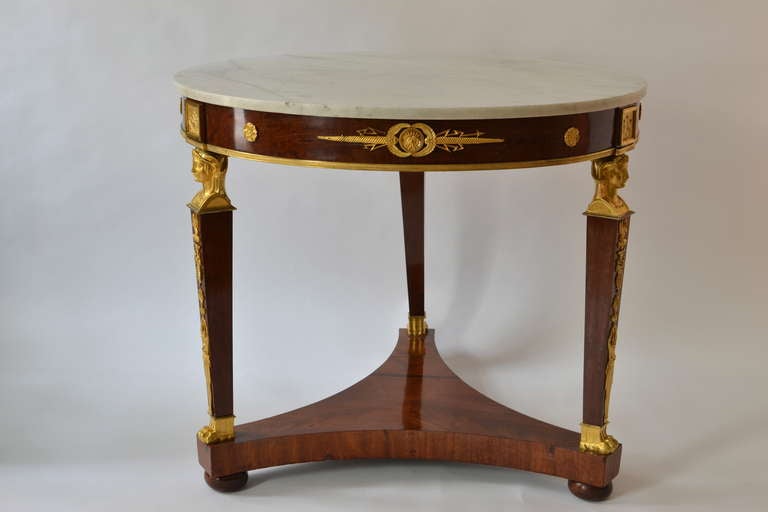 A French empire gueridon mahogany table with gilt bronze mounts made circa 1820 and with a white Italian Carrara marble top.

Dimensions: 79.0 cm x 92.0 cm