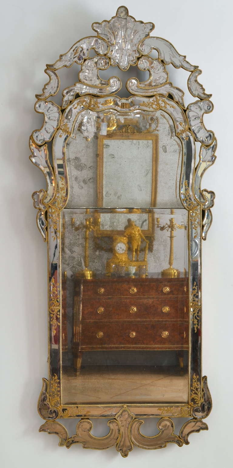 A Swedish late barque mirror made ca 1730-40. A very rare model where the frame is decorated with mirrored cut and gilded glass pieces. All glass is original but with a few cracks in some parts.