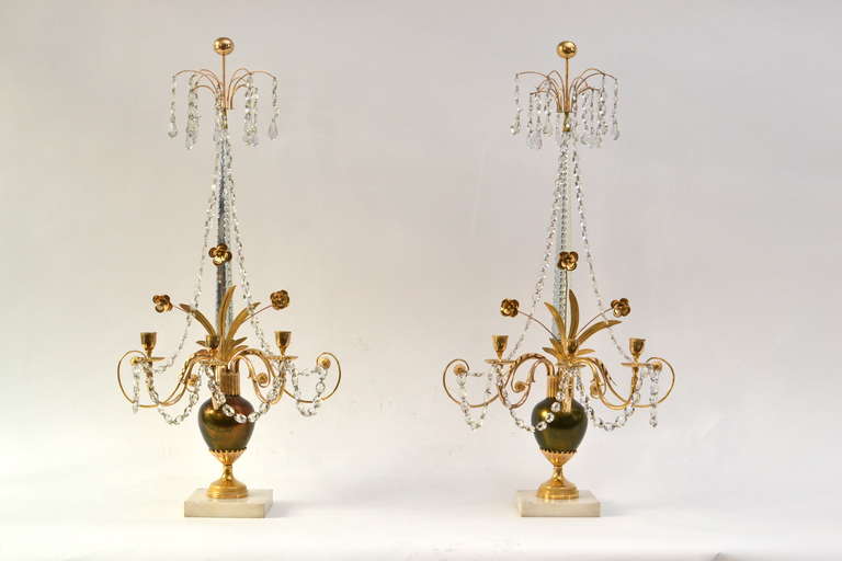 Pair of Russian gilt bronze and cut-glass three-light girandoles from the end of the 18th century. A very fine and unusual model. The central body is cast in bronze which is silvered and then applied with a thin color.