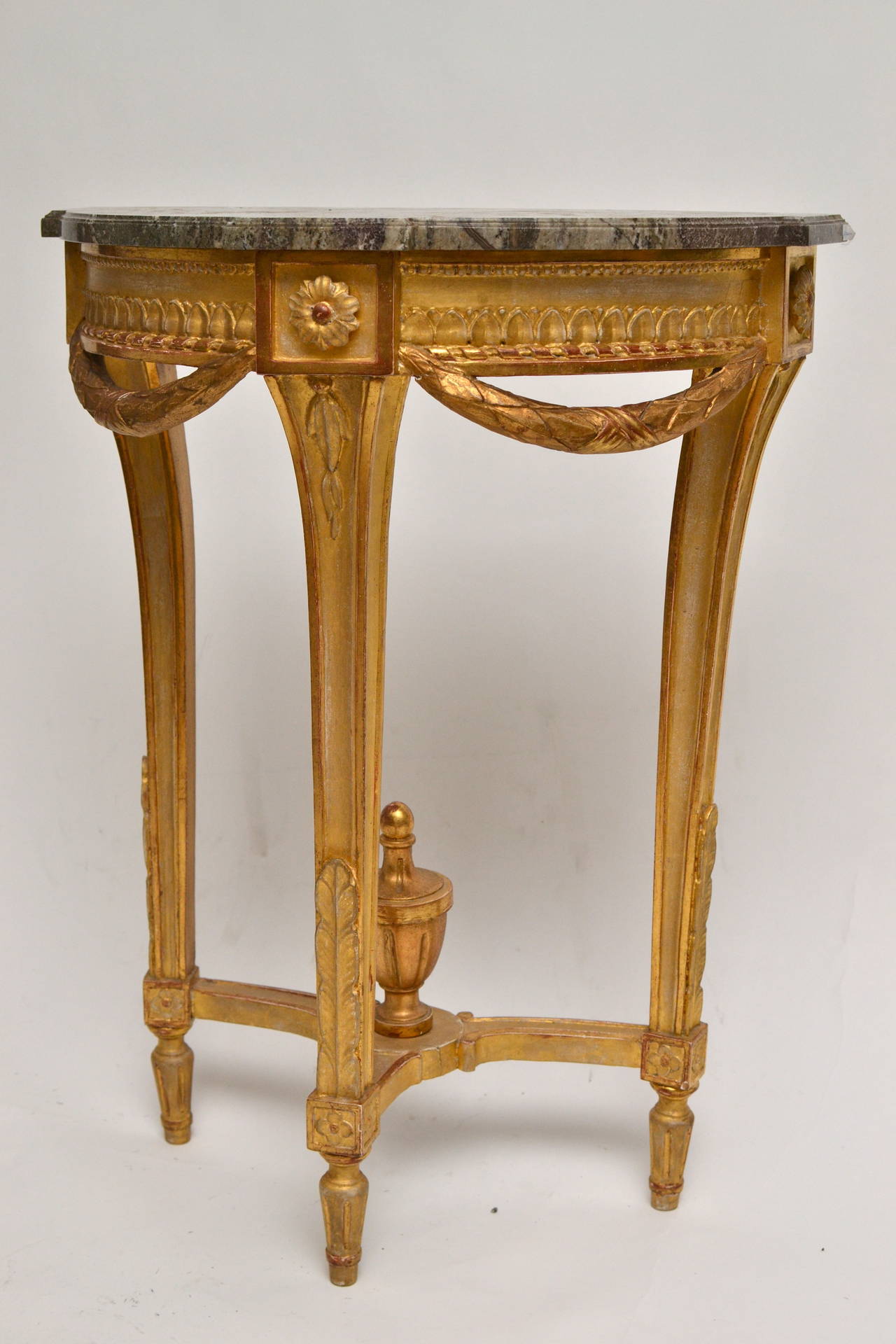 An unusually small Gustavian carved giltwood console table with a marble top made in Stockholm, circa 1790.