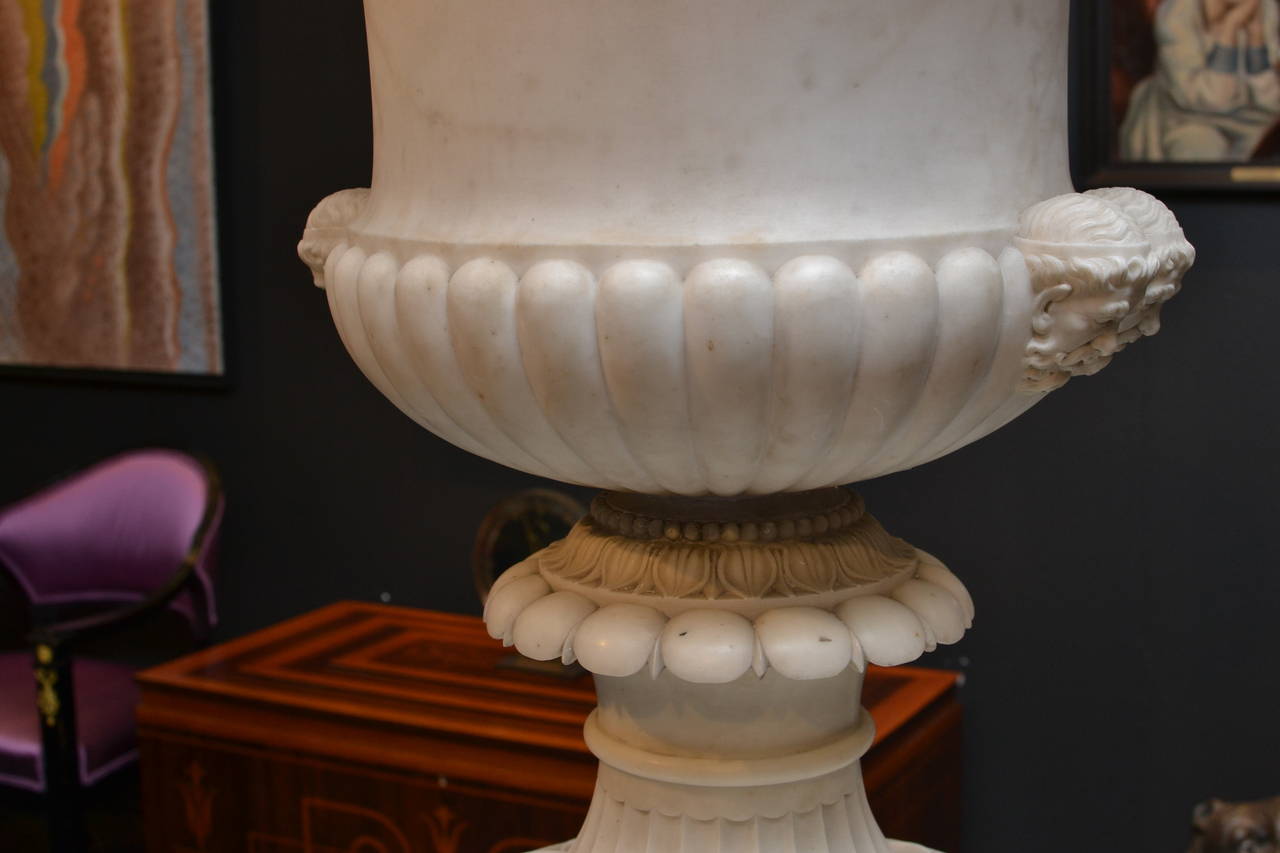 A large and important 19th century Italian Carrara marble urn on original marble stand. With a very fine detailed finish. The urn has partly a polished surface.