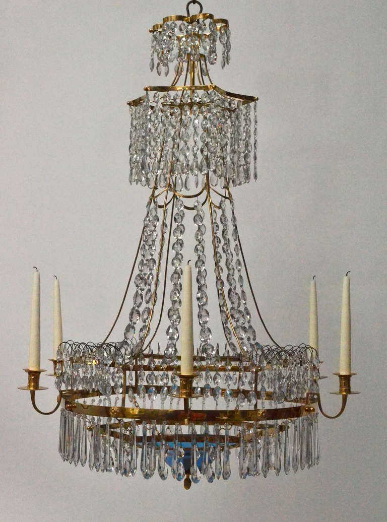 A large important Swedish chandelier from the Gustavian period made by Carl Henrik Brolin (1765-1832) circa 1805. Gilt bronze and crystals and with a blue glass bowl. Signed CHB.