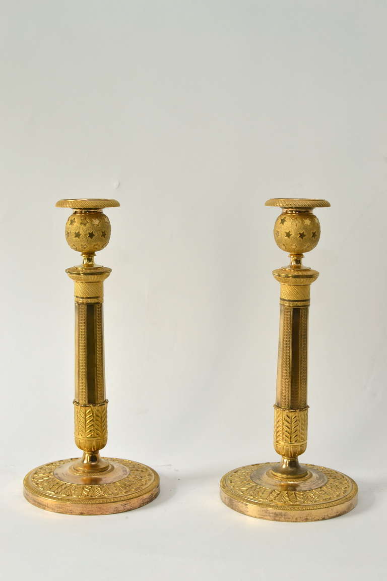 Pair of French empire gilt bronze candlesticks, circa 1810.