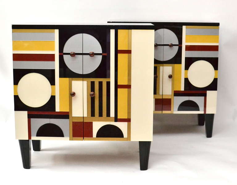 Pair of unusual glass cabinets from the 1940s or 50s. Each color is a glass piece that is cut and lacquered on the inside and then applied in different levels on the cabinet.