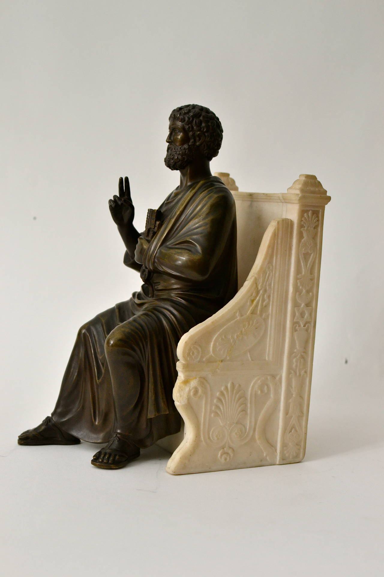 A bronze sculpture of St. Peter seated on a alabaster throne chair, 19th century after Arnolfo di Cambio (1245-1302).