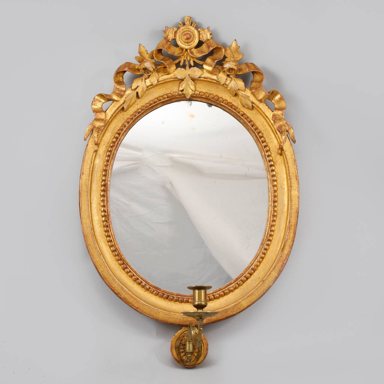 Pair of 18th century oval Swedish gustavian carved gilt wood girandole mirrors with bronze candleholders.