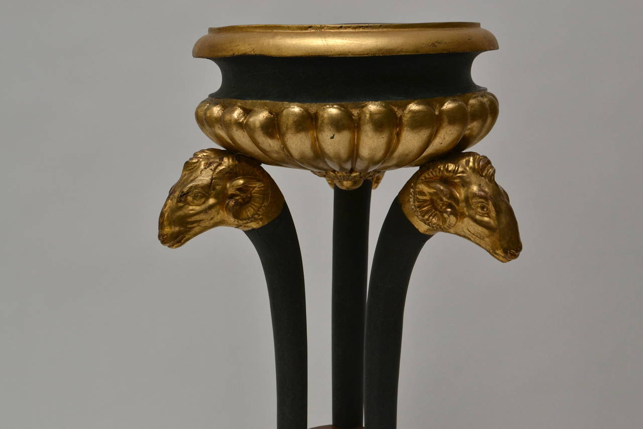 A pair of Empire gilt and patinated wood and mahogany veneered Gueridons, early 19th century.