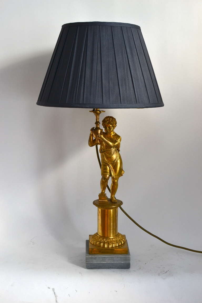 A French candelabra now mounted as a lamp, circa 1820. Gilt bronze.