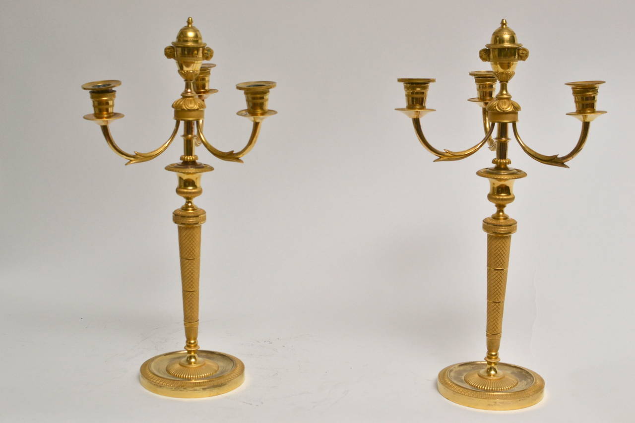 Pair of fine quality French empire candelabra with the central nozzle as a cassolette. The candelabra arms detachable which transforms the candelabras to a nice pair of candlesticks.