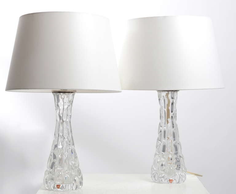 A pair of table lamps in glass by Carl Fagerlund for Orrefors, Sweden.

37 cm high without shades. 50 cm with shades.