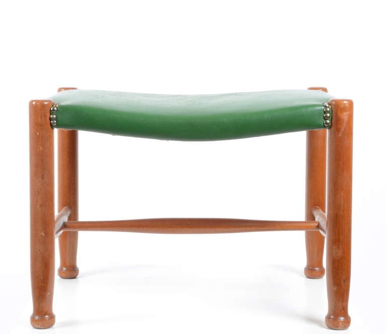 A stool designed by Josef Frank for Svenskt Tenn in green leather.