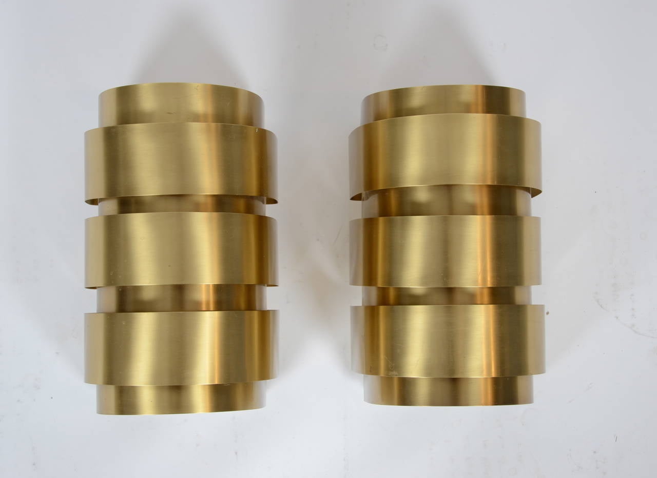 A pair of brass sconces by Hans-Agne Jakobsson for Markaryd, designed in the 1960s. Brass sheet, partly painted white.

Three pairs are available.