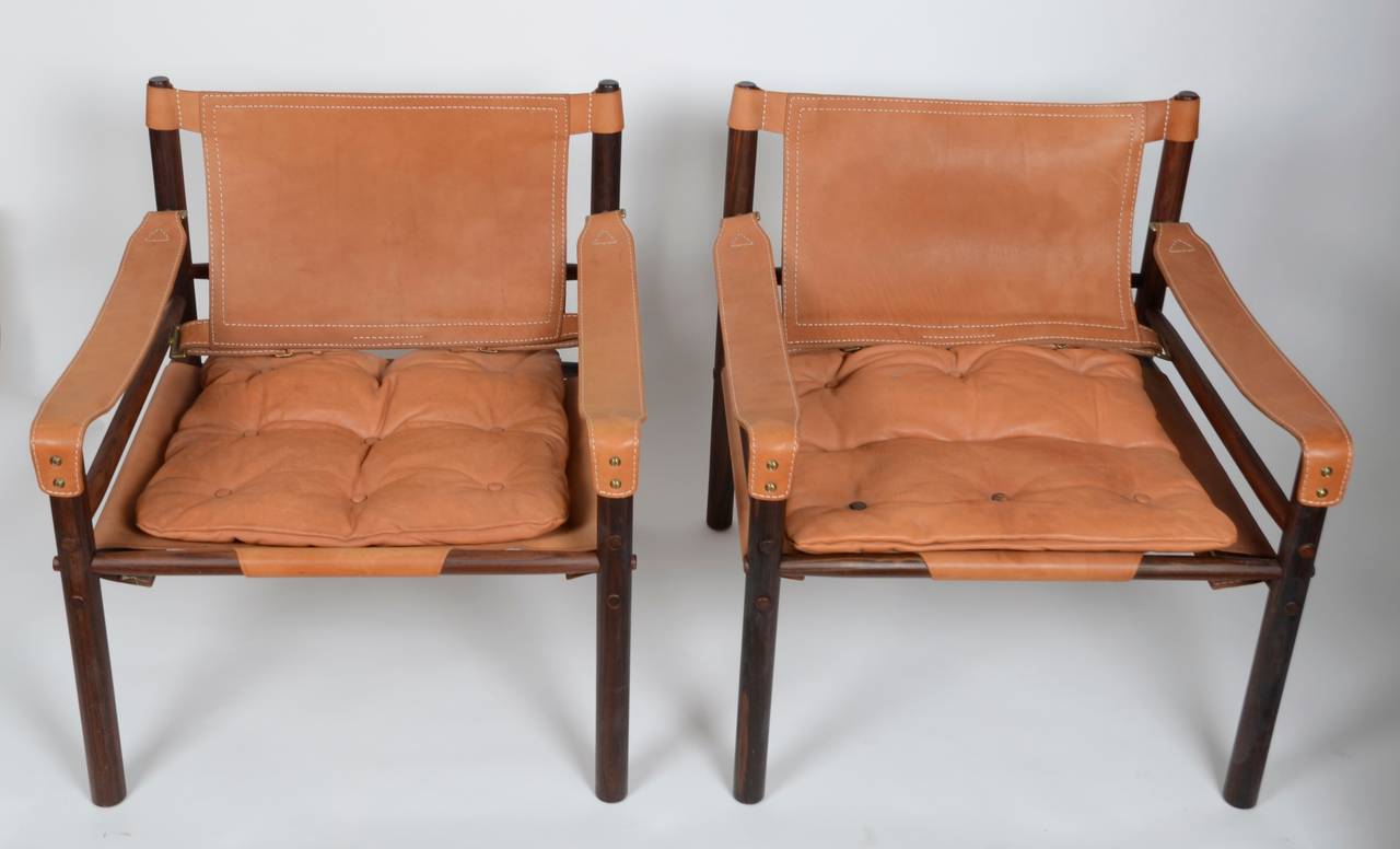 A pair of easy chairs, model Sirocco, with side table in rosewood and brass. Designed by Arne Norell, 1964 for Norell Möbler, Sweden.