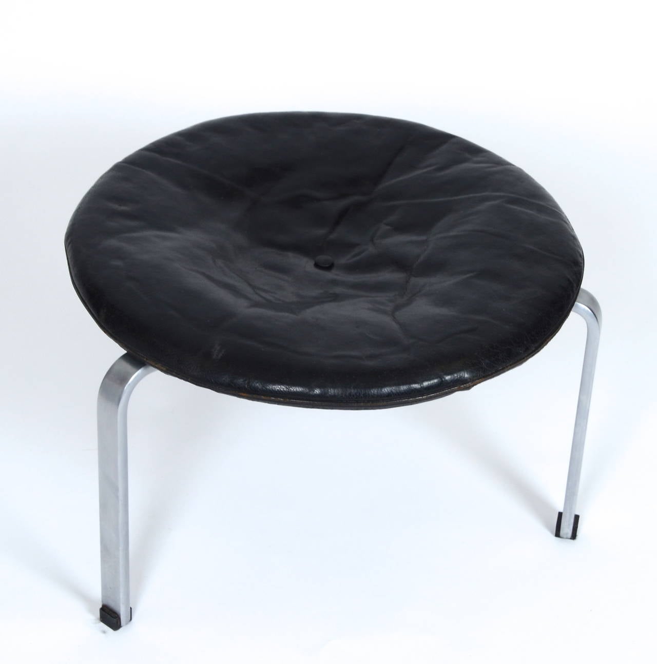 Stool model PK33 with steel frame and cushion in original black leather. 

Designed by Poul Kjærholm, 1958. Manufactured and marked E. Kold Christensen.